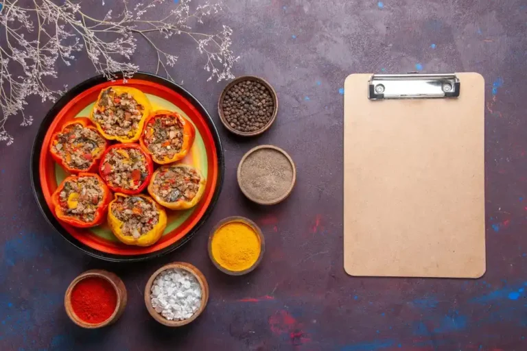 top-view-cooked-bell-peppers-with-ground-meat-different-seasonings-grey-surface-meal-dolma-food-vegetables-beef-meat_140725-74544